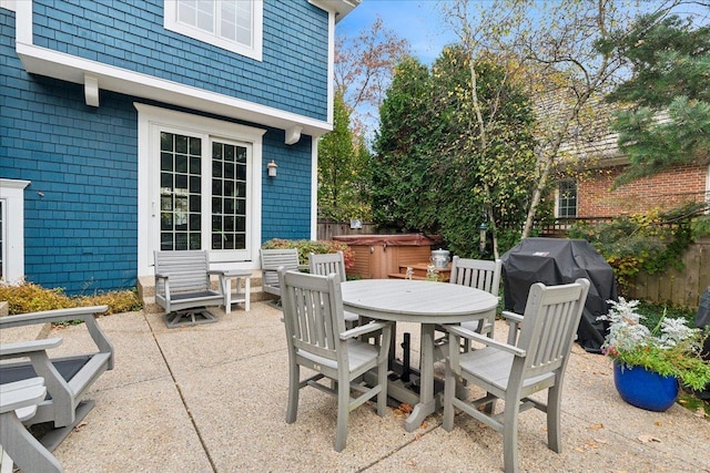 view of patio / terrace with a hot tub and area for grilling