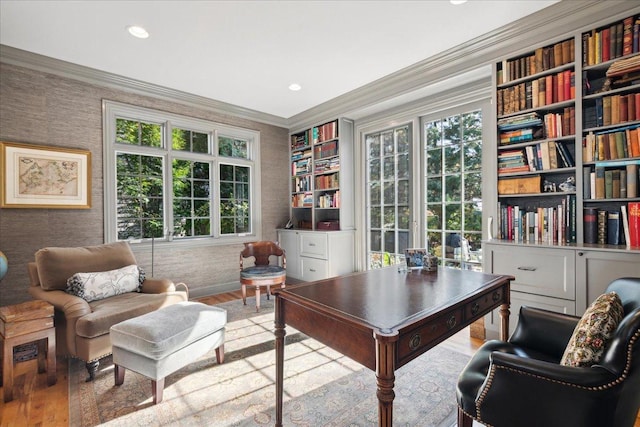 office with ornamental molding and light hardwood / wood-style floors