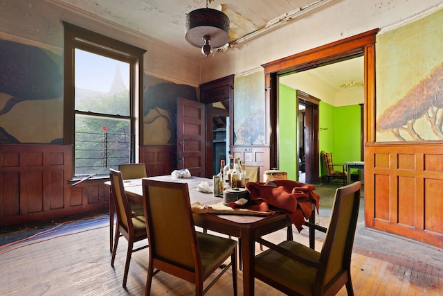 dining room with crown molding and light hardwood / wood-style floors