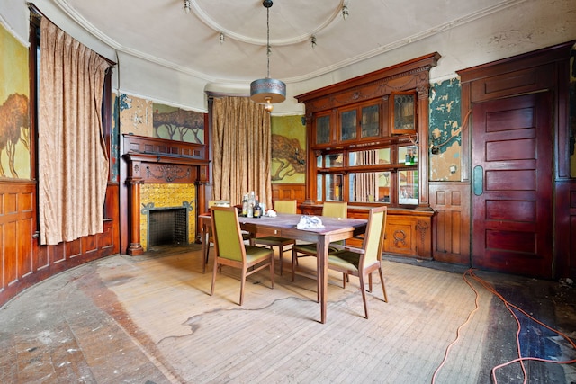 dining room with crown molding and wood walls