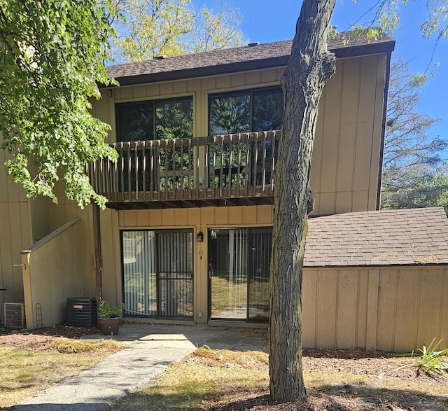 back of house featuring a balcony and central air condition unit