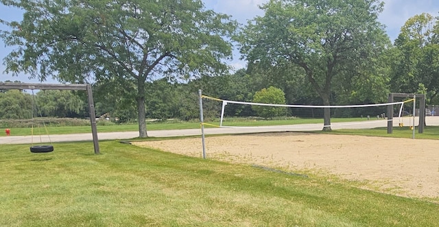 surrounding community featuring a yard and volleyball court