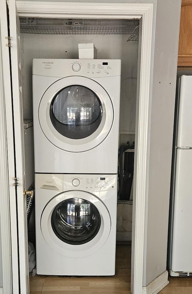 11 Saint Thomas Colony Unit 4, Fox Lake, IL 60020 - laundry room with stacked washer / dryer and wood finished floors