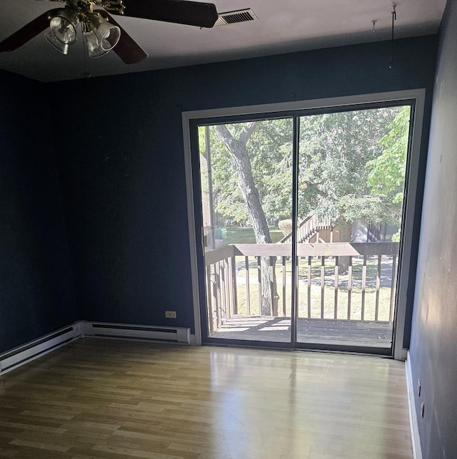 11 Saint Thomas Colony Unit 4, Fox Lake, IL 60020 - unfurnished room with ceiling fan, wood finished floors, and a baseboard heating unit