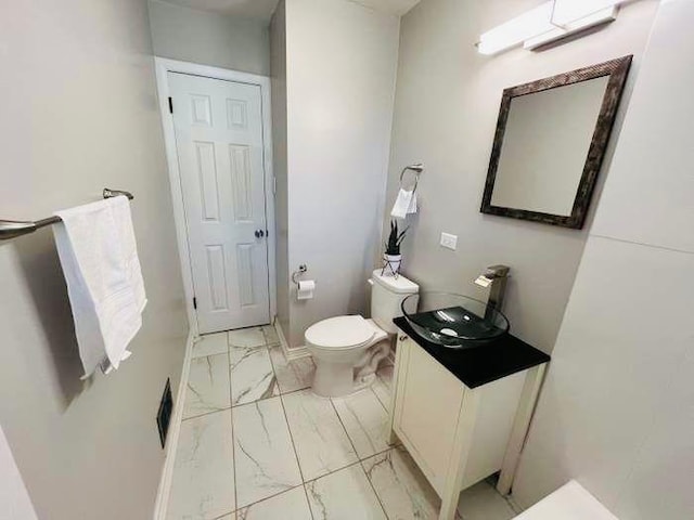 bathroom featuring vanity and toilet