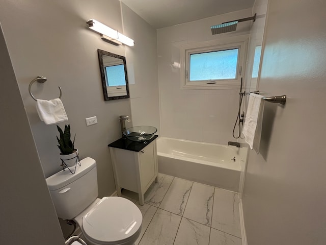 full bathroom featuring tiled shower / bath, vanity, and toilet