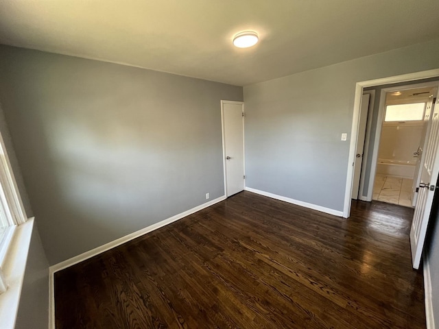 spare room featuring dark hardwood / wood-style flooring