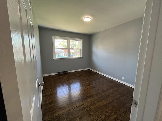 spare room featuring dark hardwood / wood-style flooring