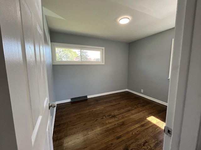 spare room featuring dark hardwood / wood-style floors