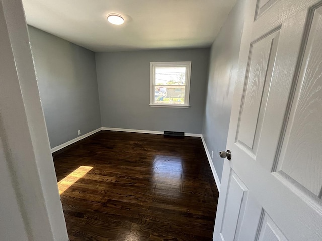 unfurnished room featuring dark hardwood / wood-style floors