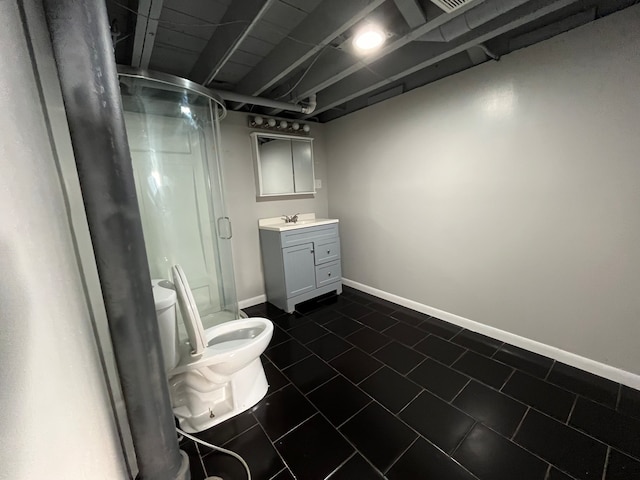 bathroom featuring tile patterned floors, vanity, toilet, and a shower with shower door