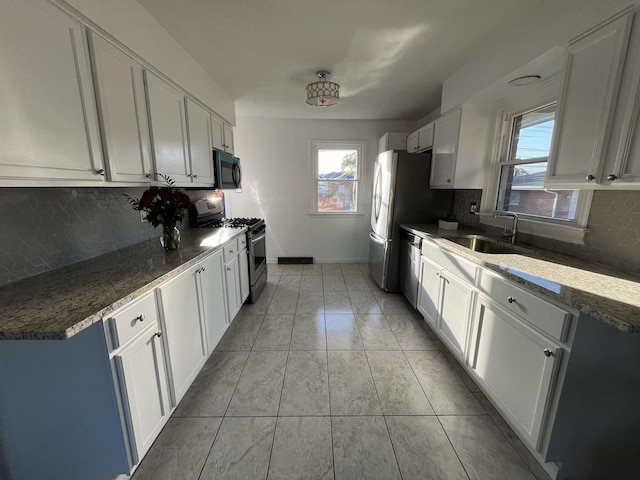 kitchen featuring white cabinetry, appliances with stainless steel finishes, and sink