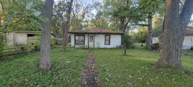 view of outbuilding featuring a lawn