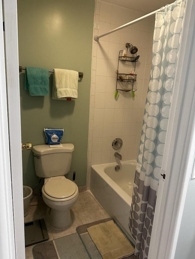 bathroom featuring toilet, tile patterned flooring, and shower / tub combo