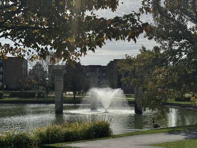 surrounding community featuring a water view