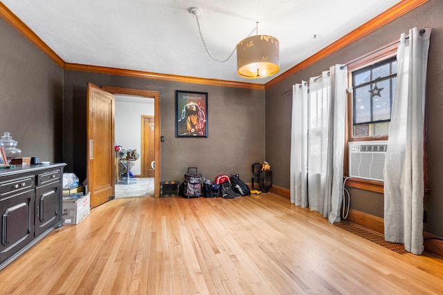 miscellaneous room with ornamental molding and light hardwood / wood-style floors