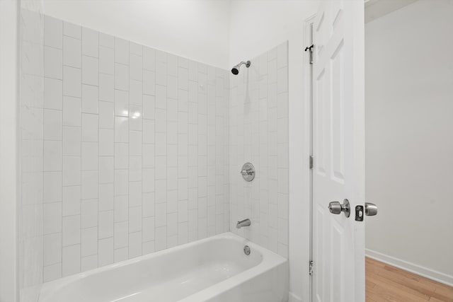 bathroom featuring hardwood / wood-style flooring and tiled shower / bath combo