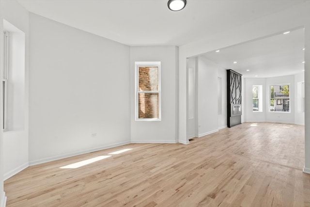 empty room with light hardwood / wood-style flooring