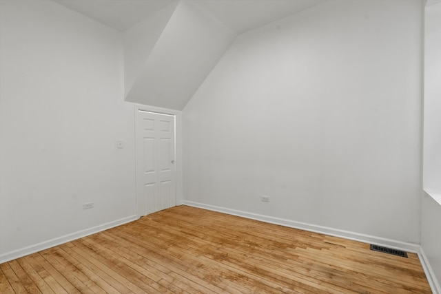 bonus room with light hardwood / wood-style flooring and vaulted ceiling