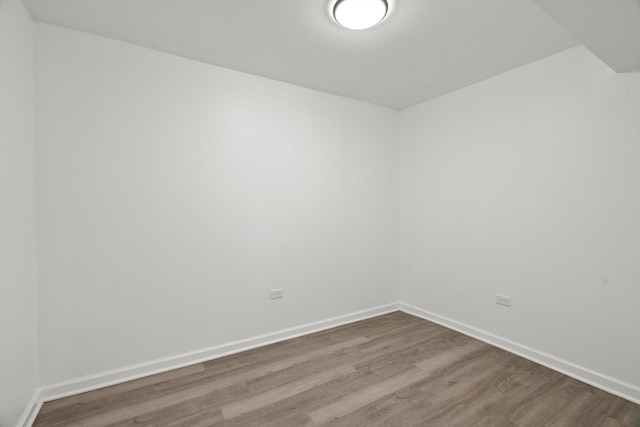 unfurnished room with hardwood / wood-style flooring