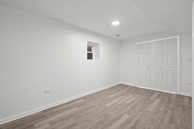 unfurnished bedroom featuring light wood-type flooring and a closet