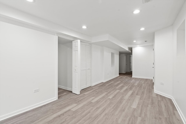 basement with light hardwood / wood-style floors