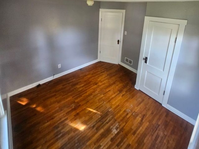 spare room featuring dark hardwood / wood-style flooring