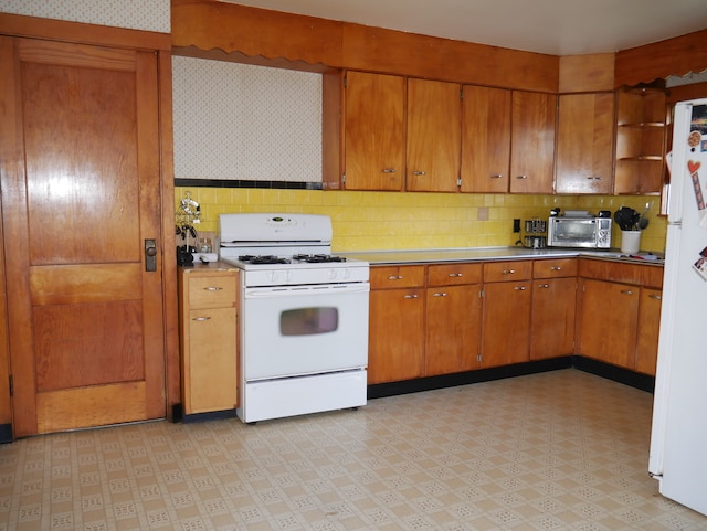 kitchen with tasteful backsplash and white appliances