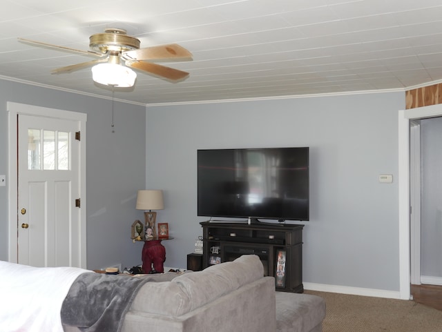 carpeted living room with ceiling fan and crown molding