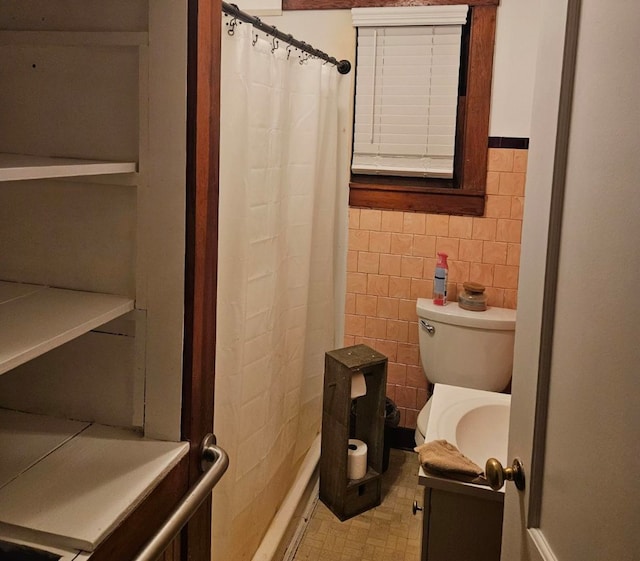 bathroom with tile walls, vanity, curtained shower, and toilet