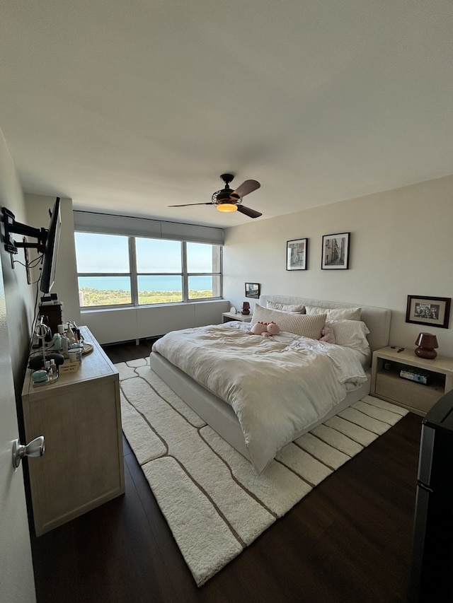 bedroom featuring ceiling fan and dark hardwood / wood-style floors