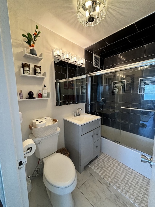 full bathroom with combined bath / shower with glass door, vanity, and toilet