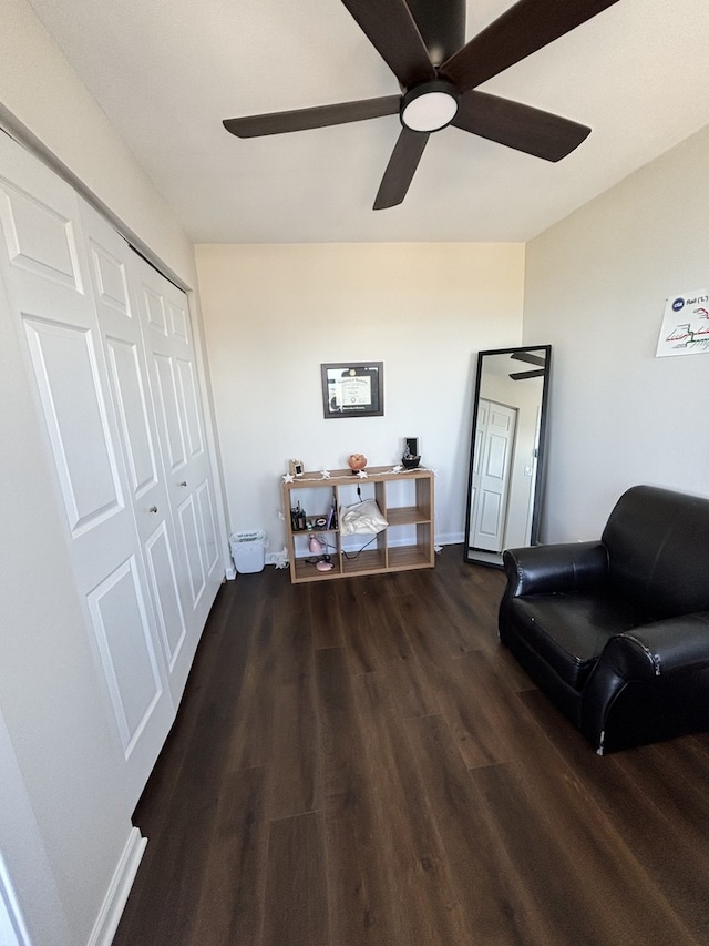 sitting room with ceiling fan and dark hardwood / wood-style flooring