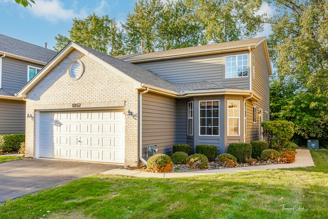 front of property featuring a front yard and a garage