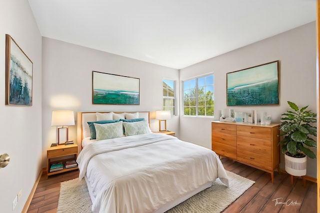 bedroom with dark wood-type flooring