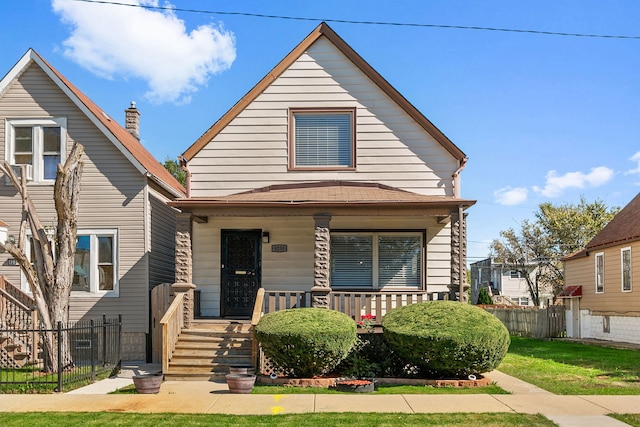 bungalow-style house featuring a porch and a front yard