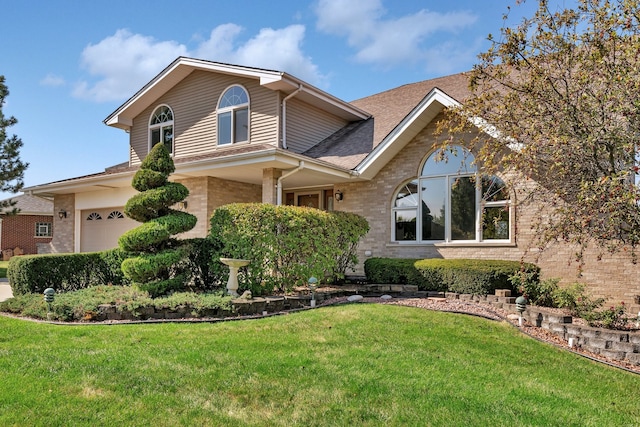 view of front property with a front lawn and a garage