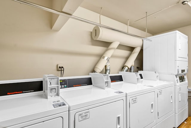 community laundry room with stacked washer and clothes dryer and independent washer and dryer