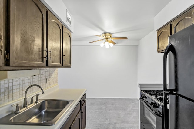 kitchen with black appliances, a sink, backsplash, carpet flooring, and baseboards