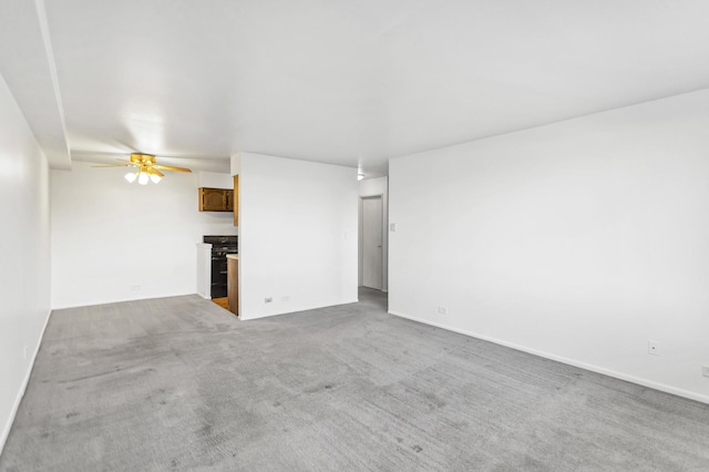 unfurnished living room with a ceiling fan and carpet floors