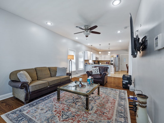 living room featuring wood-type flooring and ceiling fan