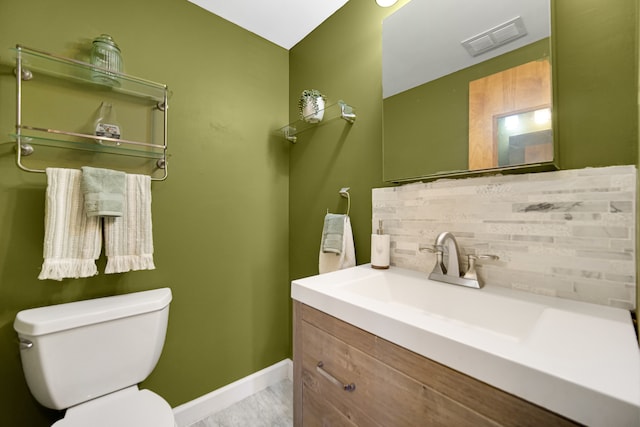 bathroom with hardwood / wood-style floors, tasteful backsplash, vanity, and toilet