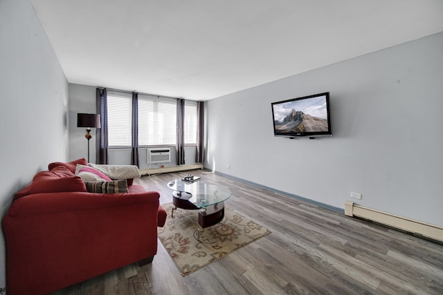 living room with cooling unit, baseboard heating, hardwood / wood-style floors, and a wall of windows