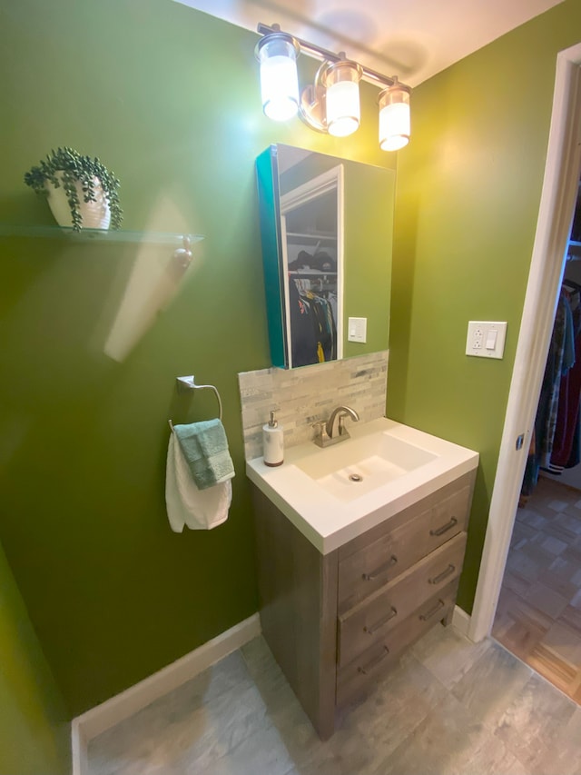 bathroom featuring vanity and tasteful backsplash