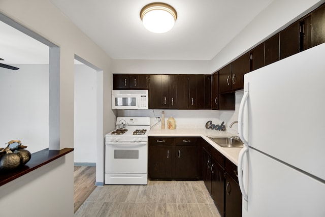 kitchen featuring white appliances, light hardwood / wood-style floors, dark brown cabinetry, and sink