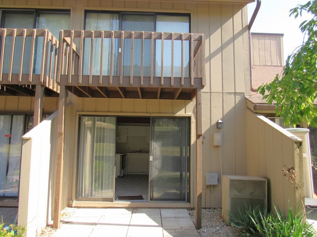 view of exterior entry featuring a balcony