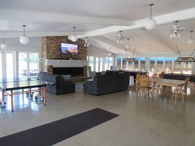 interior space featuring a brick fireplace, vaulted ceiling with beams, and ceiling fan