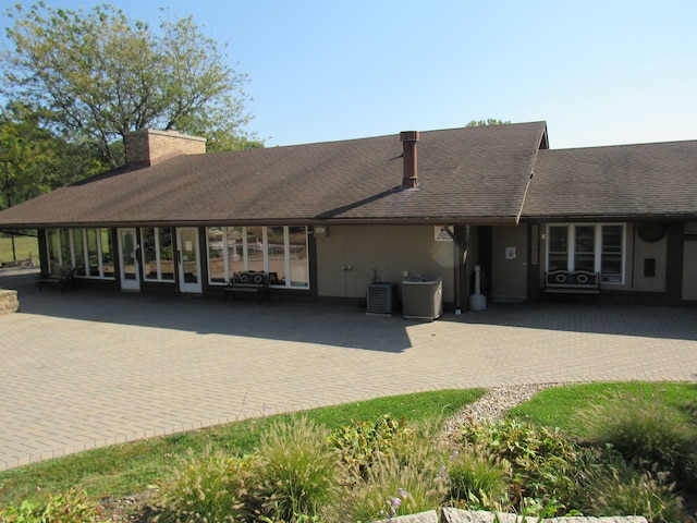 exterior space with central AC unit and a carport