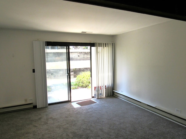 unfurnished room with carpet flooring and a baseboard heating unit