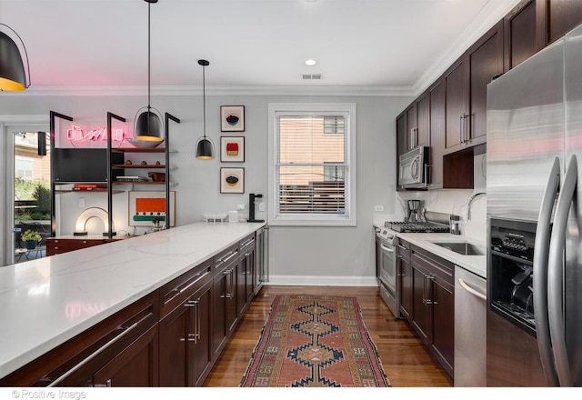 kitchen featuring sink, crown molding, appliances with stainless steel finishes, hanging light fixtures, and dark hardwood / wood-style flooring